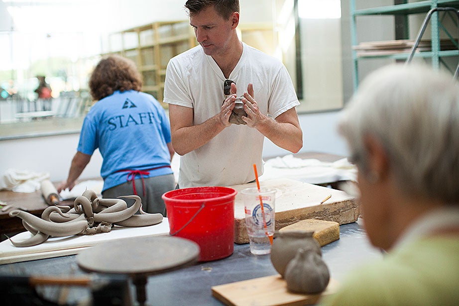 Christopher Adam ’94 works diligently among the other ceramics students. 