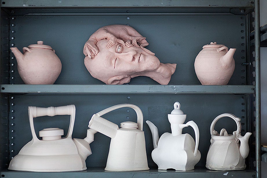 Bisque-fired and glazed ceramic pieces are found throughout the studio.