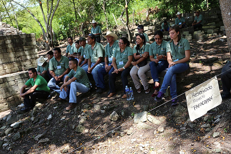 Members of the field team Proyecto Arqueológico Rastrojón Copán (PARACOPAN), composed of local Copán residents and Harvard students, listen to opening remarks during the site’s official unveiling in August.