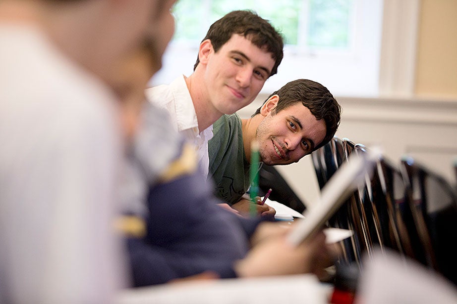 Elliot Wilson ’15 (left) and Stefan Poltorzycki ’15 socialize with other students before the start of Emma Dench’s class. Rose Lincoln/Harvard Staff Photographer