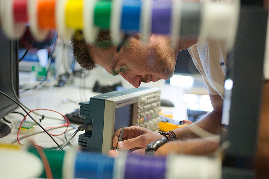Slava Arabagi works on soft sensor fabrication at the Harvard Microrobotics Laboratory. 