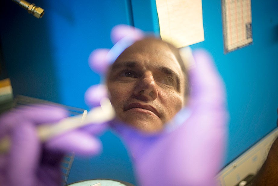 Postdoctoral researcher Mike Wehner reflected in a molding of soft robot materials made in the Harvard Microrobotics Lab. 