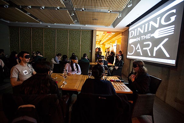 Dining in the Dark gathered around 30 participants from the Harvard Graduate School of Education. Students Cass Walker (left) and Nina Boonyaleepun fumbled to greet each other (photo 2) — because all students were required to wear blindfolds upon entry (photo 3). 