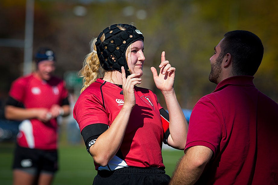 Helen Clark passes an on-field concussion test administered by athletic trainer Corey Lanois during the Princeton game. Helmets are not required but some players wear them to protect against cauliflower ear, a complication resulting from ear injuries.