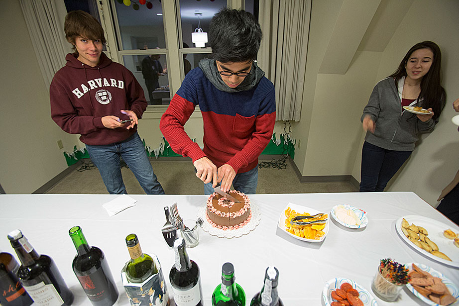 Leverett House "Not Just Sherry Hour": Kelly Maeshiro '14 (left) watches as Benjamin Antillon '14 cuts a cake at swing housing at 20-62 DeWolfe.