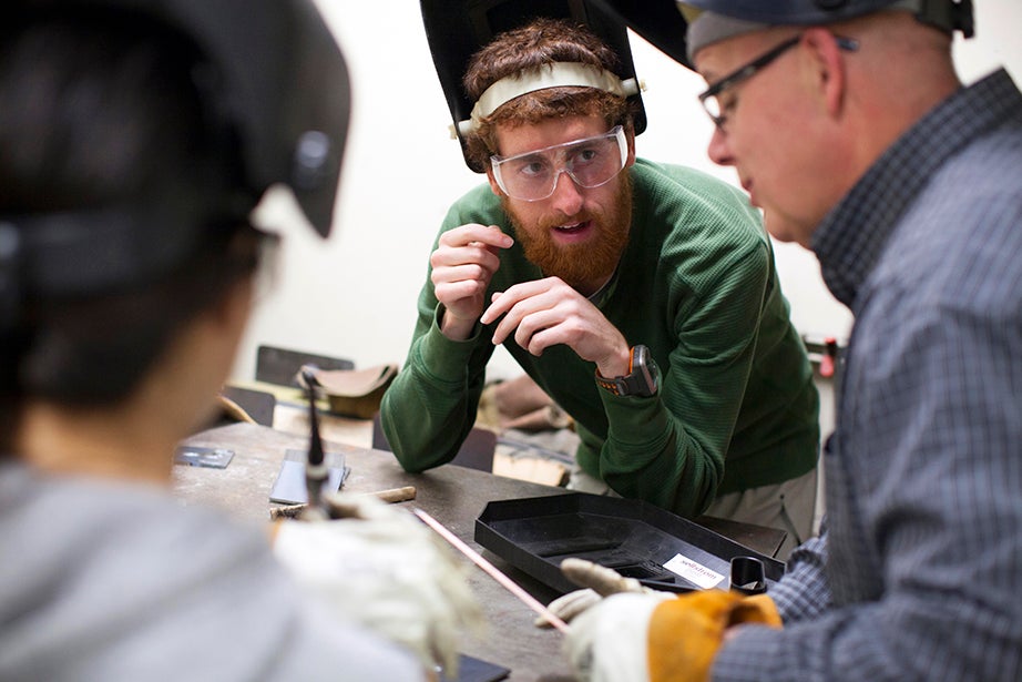 Stan Cotreau, machine shop manager in the Lyman Lab, teaches graduate students Paola Mariselli (left) and Mike Popejoy basic welding techniques. Stephanie Mitchell/Harvard Staff Photographer