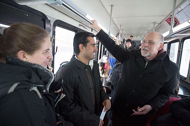 Interim College Dean Donald H. Pfister invited students to ride the shuttle from Memorial Hall to the river Houses. As the shuttle flashed "Dean on Board," Caroline Brennan '15 (from left, photo 1) and Sergio Morales '15 weren't shy about approaching Pfister. David Hu '16 (photo 2), Kenyatta Smith '15 (from left, photo 3), and Leah Singer '16 also talked to Pfister, who was handing out bookmarks with his office hours on the back.