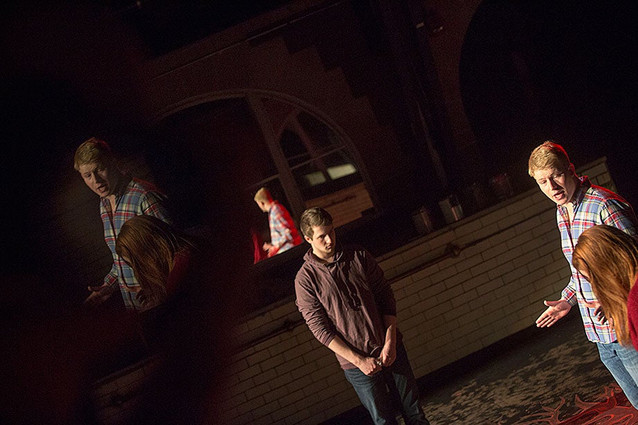 Matt Bialo ’15 (from center to right), Jonathan “J.J.” Longcroft ’15, and Taylor Phillips ’13 rehearse “In the Dark” inside the Adams House Pool Theater. 
