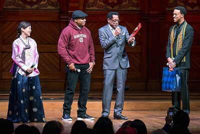 LL Cool J (second from left) was presented  the Harvard Foundation's Artist of the Year award by S. Allen Counter. “There’s been no one more committed to young people’s education than LL Cool J,” Counter said. Aubrey Walker ’15 and Soyoung Kim '14,  co-directors of Cultural Rhythms, shared the Sanders Theatre stage during Saturday's award presentation.