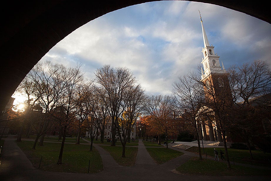 Memorial Church is framed by the shadow of Sever Hall’s arch.