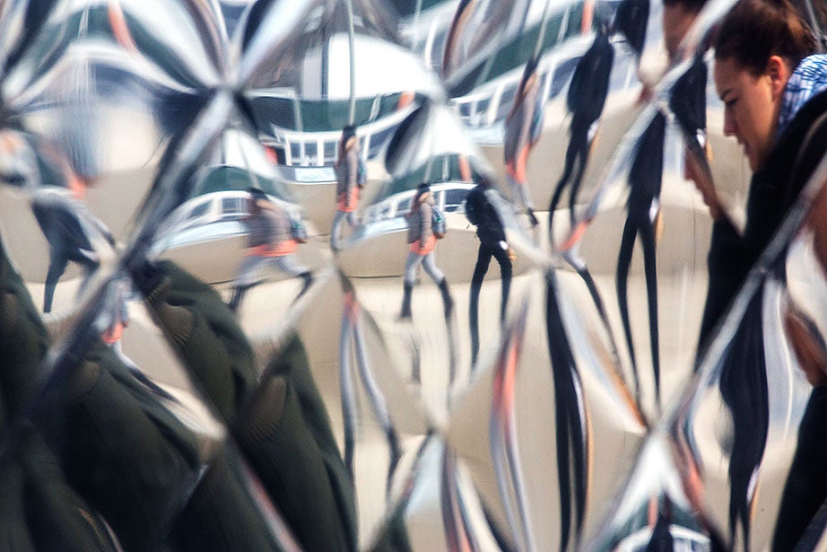 The reflection from the metallic surface of a food truck refrigerator gives a kaleidoscopic view of pedestrians in the Science Center Plaza.