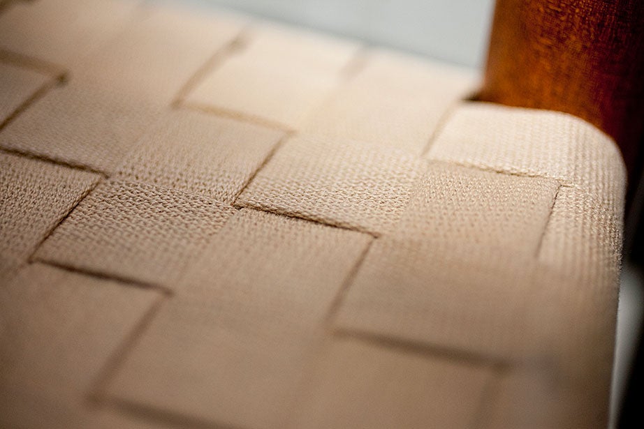 The woven seat of a Shaker chair.