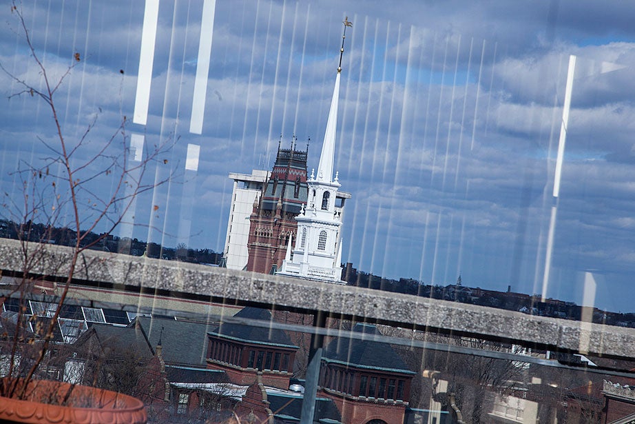 The Memorial Church (front), Memorial Hall, and William James Hall are seen through the blinded windows of The Richard A. and Susan F. Smith Campus Center.
