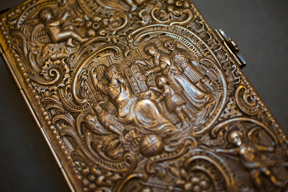 An elaborate silver relief binding covers a 1763 work by German scholar Johann Peter Miller.