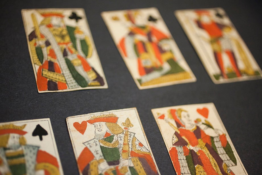 The collection includes a series of woodcut, hand-colored playing cards, circa 1750.