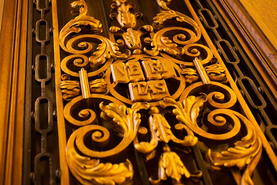 A Veritas shield adorns the entrance to the room.