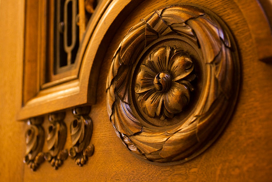Intricate woodcarvings adorn the entrance to the room.