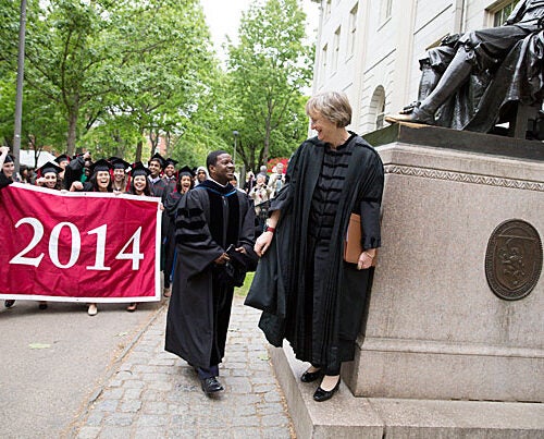 Plummer Professor of Christian Morals and Pusey Minister Jonathan Walton and Harvard President Drew Faust led a procession (photo 1) into Memorial Church for the annual Baccalaureate Service, during which Faust urged seniors like Katie Hernandez (left, photo 2) and Caroline Davis to “break good,” “face outward,” and act for the betterment of the larger community. “This week is neither one of culmination nor conclusion," said Walton in his talk. "It is Commencement. It is just the beginning.”