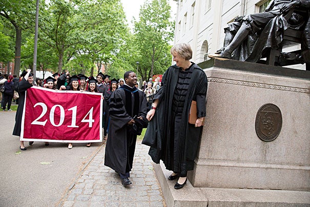 Plummer Professor of Christian Morals and Pusey Minister Jonathan Walton and Harvard President Drew Faust led a procession (photo 1) into Memorial Church for the annual Baccalaureate Service, during which Faust urged seniors like Katie Hernandez (left, photo 2) and Caroline Davis to “break good,” “face outward,” and act for the betterment of the larger community. “This week is neither one of culmination nor conclusion," said Walton in his talk. "It is Commencement. It is just the beginning.”