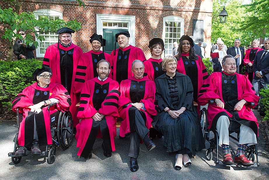 President Drew Faust (center, in black) and Harvard Provost Alan Garber (front row, second from left) pose with this year's honorary degree recipients: (front row, from left) Seymour Slive, Michael Bloomberg, former President George H.W. Bush, Peter Raven (back row, left to right), Patricia King, Joseph E. Stiglitz, Isabel Allende, and Aretha Franklin. Jon Chase/Harvard Staff Photographer