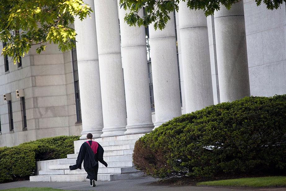 A lone graduate passes the Littauer Building on Commencement morning. Stephanie Mitchell/Harvard Staff Photographer