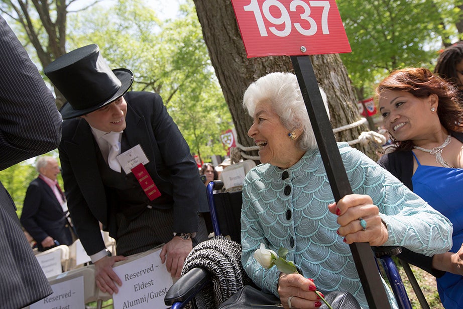 During the Annual Meeting of the Harvard Alumni Association, the oldest alumna in attendance, Lillian Sugarman ’37, heads the row and shares a laugh with Happy Committee member Brandon Geller. Kris Snibbe/Harvard Staff Photographer
