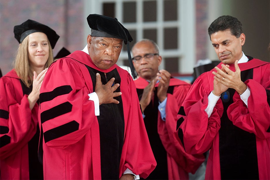 John Lewis (center), U.S. representative from Georgia since 1987, is touched by the audience's ovation at the 2012 Commencement. A leader of the Civil Rights Movement, Lewis became nationally known during his prominent role in the Selma-to-Montgomery marches in 1965. Despite numerous beatings, Lewis emerged as a leader for his courage and commitment to nonviolence. Jon Chase/Harvard Staff Photographer