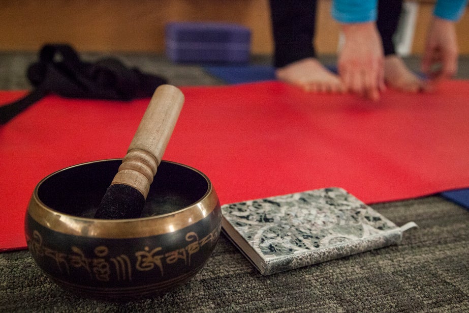 A Tibetan singing bowl and book of quotes create a serene environment. 