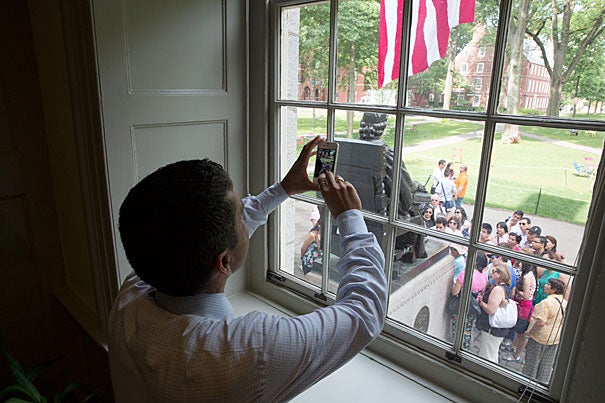 “I can’t help but remember that 43 years ago this month, my family immigrated to the United States," said Rakesh Khurana, Harvard College's new dean (photo 1). "Looking outside my window and seeing the flag and the John Harvard Statue, I just feel incredible gratitude to my parents, who had the courage to come to this nation." Khurana greeted guests outside his office (photo 2), while inside he read cards from well-wishers, complete with orchids (photo 3).