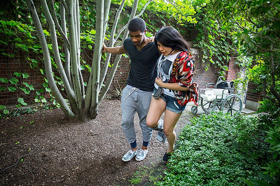 Gerry Ambroise walks the garden — shared with birds, squirrels, and bunnies ― with Annielly Camargo, a student in Crimson Summer Academy.