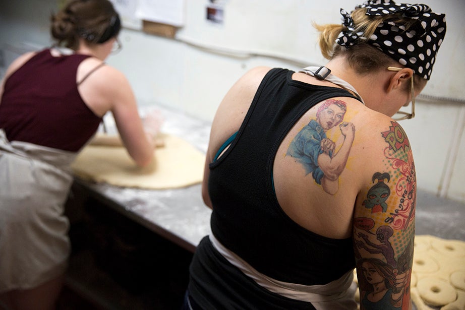 Sarah Willis (from left) and Hillary Brown roll pastry dough inside the kitchen. Their work typically starts around 4 a.m.