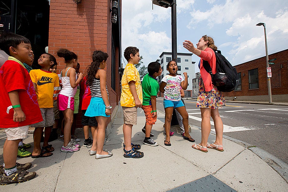 Campers sang and chanted, with the guidance of Halie Olson, as they headed back to the Condon School after a field trip to Harvard Square.