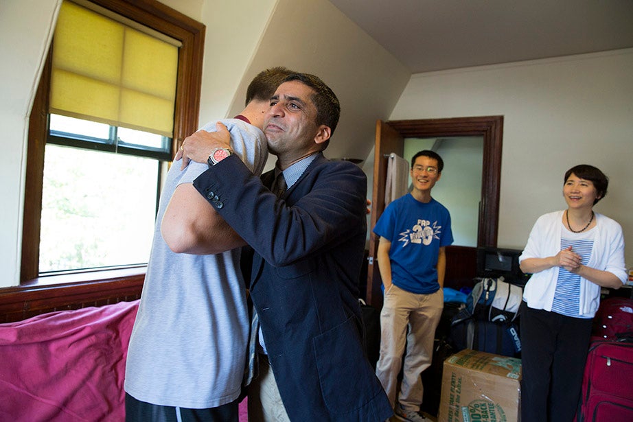 Harvard College Dean Rakesh Khurana hugs Austin Harcarik ’18 in Matthews Hall.  Rose Lincoln/Harvard Staff Photographer