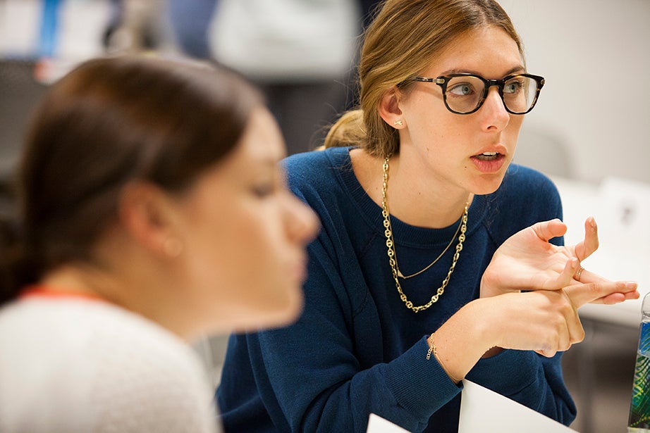 Harvard Business School student Jillian Ressler (center) makes a point during a discussion. 