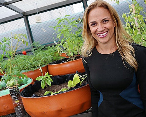 Paulina Campos, M.P.P. '07, in a rooftop garden at Infonavit, the federal institute for worker housing in Mexico. She is CEO of Fundación Hogares, a nonprofit created by Infonavit to establish community-building programs in affordable housing developments. 