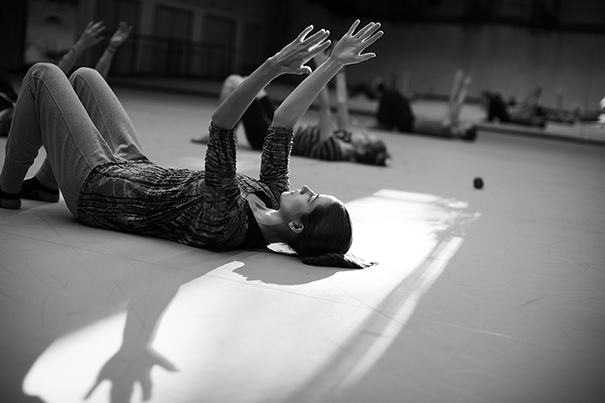 Dance Director and Senior Lecturer Jill Johnson teaches students in the classroom for the Harvard Dance Project. The students rehearse in the Harvard Dance Center at Harvard University. Whitney Cover, Ed.M. '15, (left) warms up during class. Stephanie Mitchell/Harvard Staff Photographer