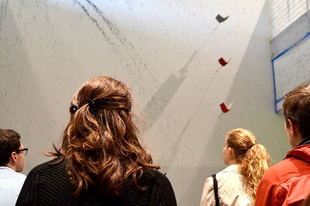 Approximately 50 people were among the select group invited to watch German artist Rebecca Horn’s “Flying Books Under Black Rain Painting” installation last week. Throughout the activation, she was in conversation with her technician (photo 2), who made adjustments from his position on a lift next to the painting machine. The final piece was completed in about eight minutes (photo 3).