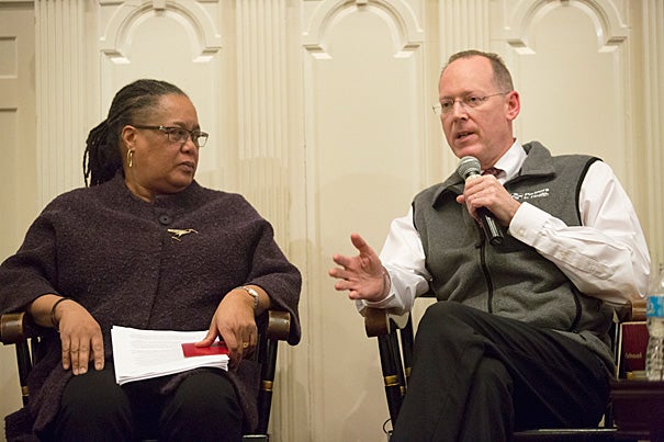 During a Harvard-sponsored forum at First Parish in Cambridge, Professor Evelynn Hammonds (left) drew attention to the fact that epidemics “pull the covers off” the ways that the poor, vulnerable, and sick are perceived. Sharing her concerns was Professor Paul Farmer: “If we had the staff, stuff, space, and systems, we could get people earlier into a place where they could get supportive care.” To date, most Americans stricken with Ebola have survived because they were “scooped out” of miserable conditions, he noted.