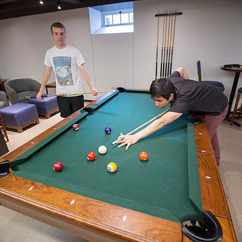 Mark Steinbach (left) and Jason Shen play pool in McKinlock Hall. Kris Snibbe/Harvard Staff Photographer