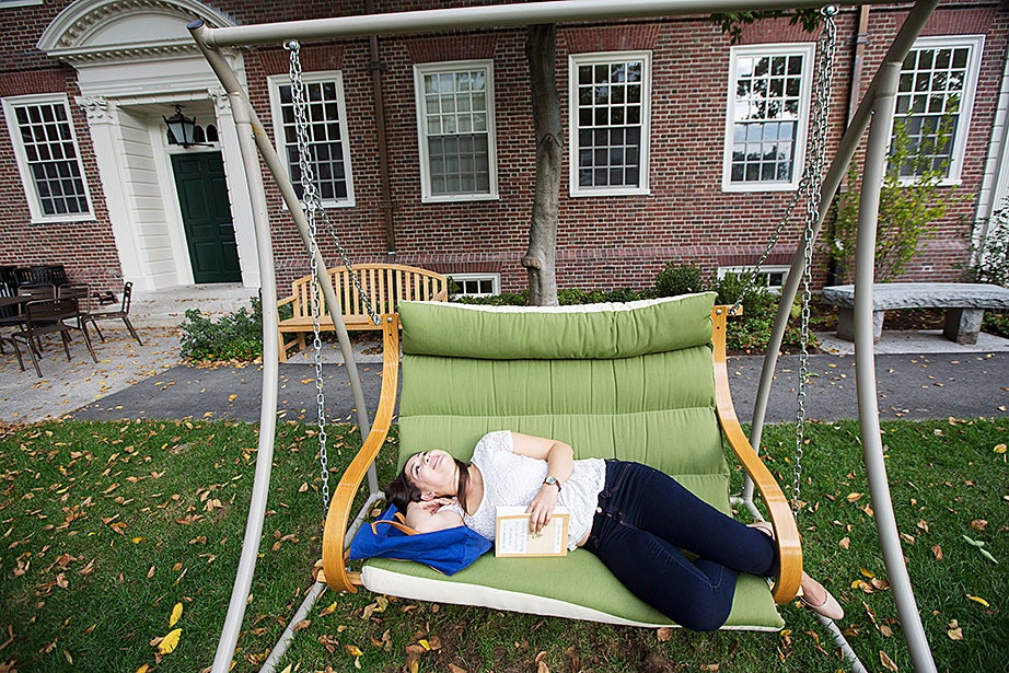 Lien Le ’17 studies on a bench swing in the courtyard of McKinlock Hall. Kris Snibbe/Harvard Staff Photographer