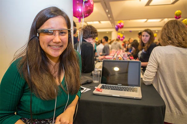 The CS50 Fair attracted hundreds to the Northwest Labs where students displayed their projects. Emilie R. Wong ’17 (photo 1), a literature student at Harvard Extension School, created a music visualization tool using Google Glass. Jacob Rienstra ’17  (photo 2), who made a catalog of the portraits in Lowell House, said, “I was always the kid at the museum who wanted to get the audio guide and listen to every entry.” Government concentrator William Anthony Greenlaw ’17 (right, photo 3),  director of Business Partnerships for Harvard’s ballroom dancing team, designed a website to recruit more competitors.