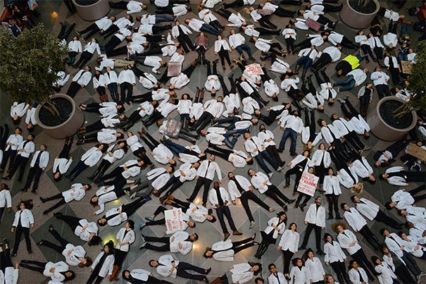 More than 100 Harvard Medical School students, joined by faculty and staff, took part in a nationwide medical student “die-in” this past Wednesday, lying on the floor of Harvard’s Tosteson Medical Education Center on Longwood Avenue in Boston for 15½ minutes (photo 1). Harvard President Drew Faust (photo 2) and Bill Lee (photo 3), the senior fellow of the Harvard Corporation, don T-shirts that read: "Black Lives Matter."
