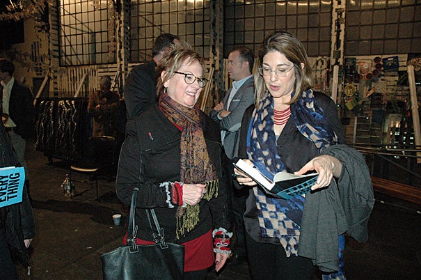 Author and syndicated columnist Naomi Klein (right) signs a copy of her latest book, “This Changes Everything: Capitalism vs. the Climate," after a matinee performance of "O.P.C.," Eve Ensler's new play at the American Repertory Theater. 