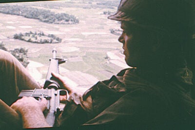 An American soldier on helicopter patrol over South Vietnam from the film “Hearts and Minds” (1974).