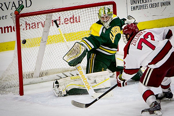 Harvard forward Phil Zielonka '17 scores the third goal on Clarkson goaltender Ville Runola during a home game at Bright-Landry Hockey Center on Jan. 16. The Crimson went on to defeat Clarkson, 6-3. On Friday, the Crimson will duel with Union, last year’s national champion.