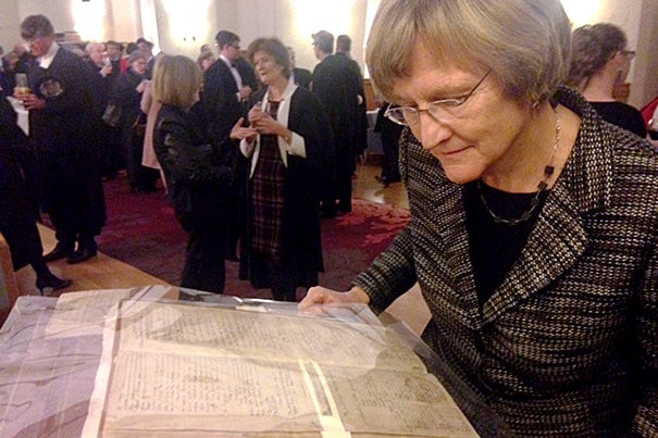 While at the University of Cambridge, Harvard President Drew Faust examined a 17th-century registration book  bearing the only known signature of a 1624 Emmanuel College matriculant named John Harvard.