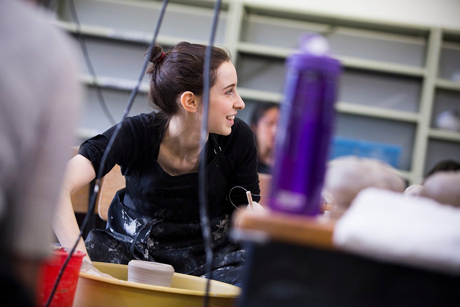 Melissa Rodman ’18 (pictured) completes a pot on the wheel. Stephanie Mitchell/Harvard Staff Photographer