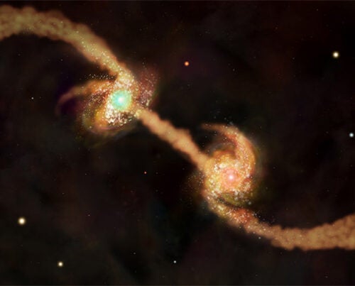 This illustration features two spiral galaxies — each with a supermassive black hole at its center — as they are about to collide and form an elliptical galaxy. New research shows that galaxies’ dark-matter halos influence these mergers and the resulting growth of supermassive black holes.