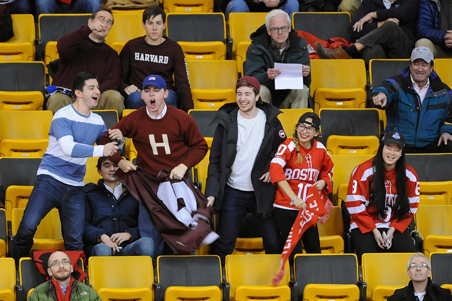 A small but vocal Crimson cheering section tries to outshout BU rivals as their teams battle on the ice. Jon Chase/Harvard Staff Photographer
