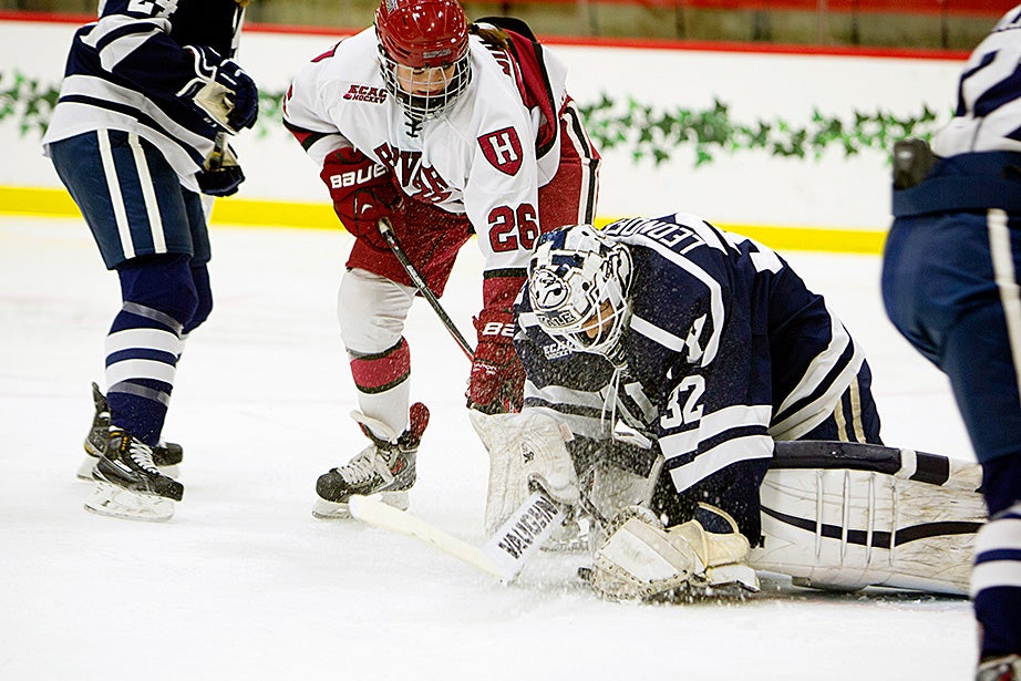 Harvard forward Haley Mullins ’18 tries to poke the puck past Yale’s goalie. Harvard won 2-1, and the following day beat Yale 3-0 to qualify for the semifinals. Rose Lincoln/Harvard Staff Photographer